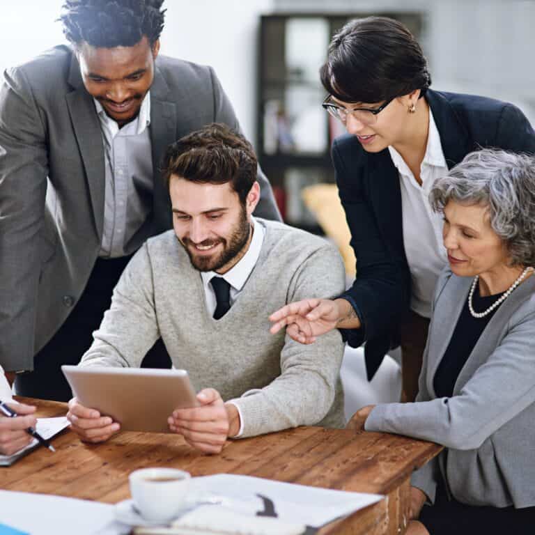 Cropped shot of a group of businesspeople working together on a digital tablet in an office