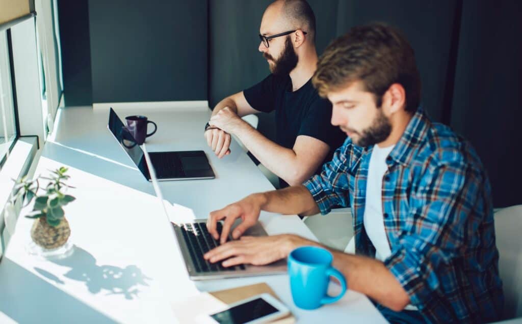 millennial men using digital technology for developing software